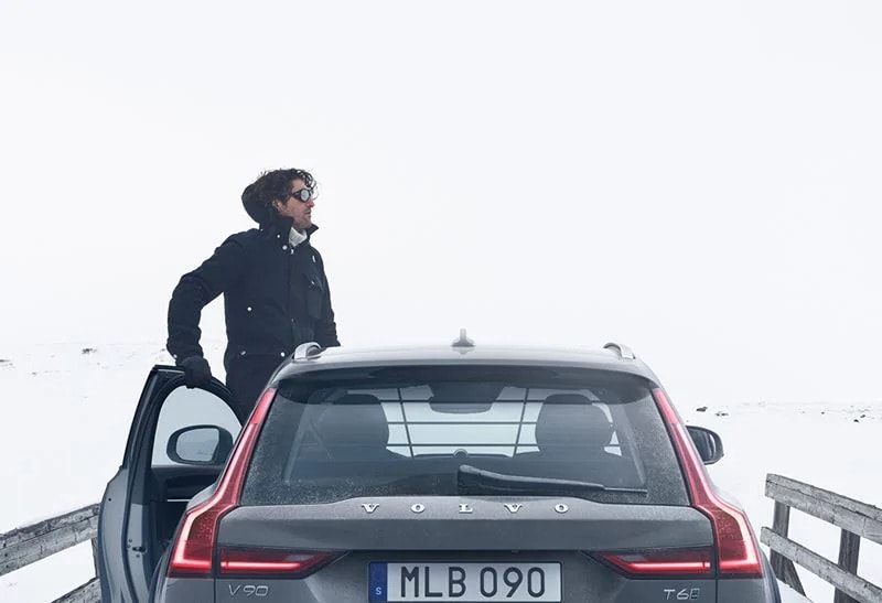A man standing out of a Volvo